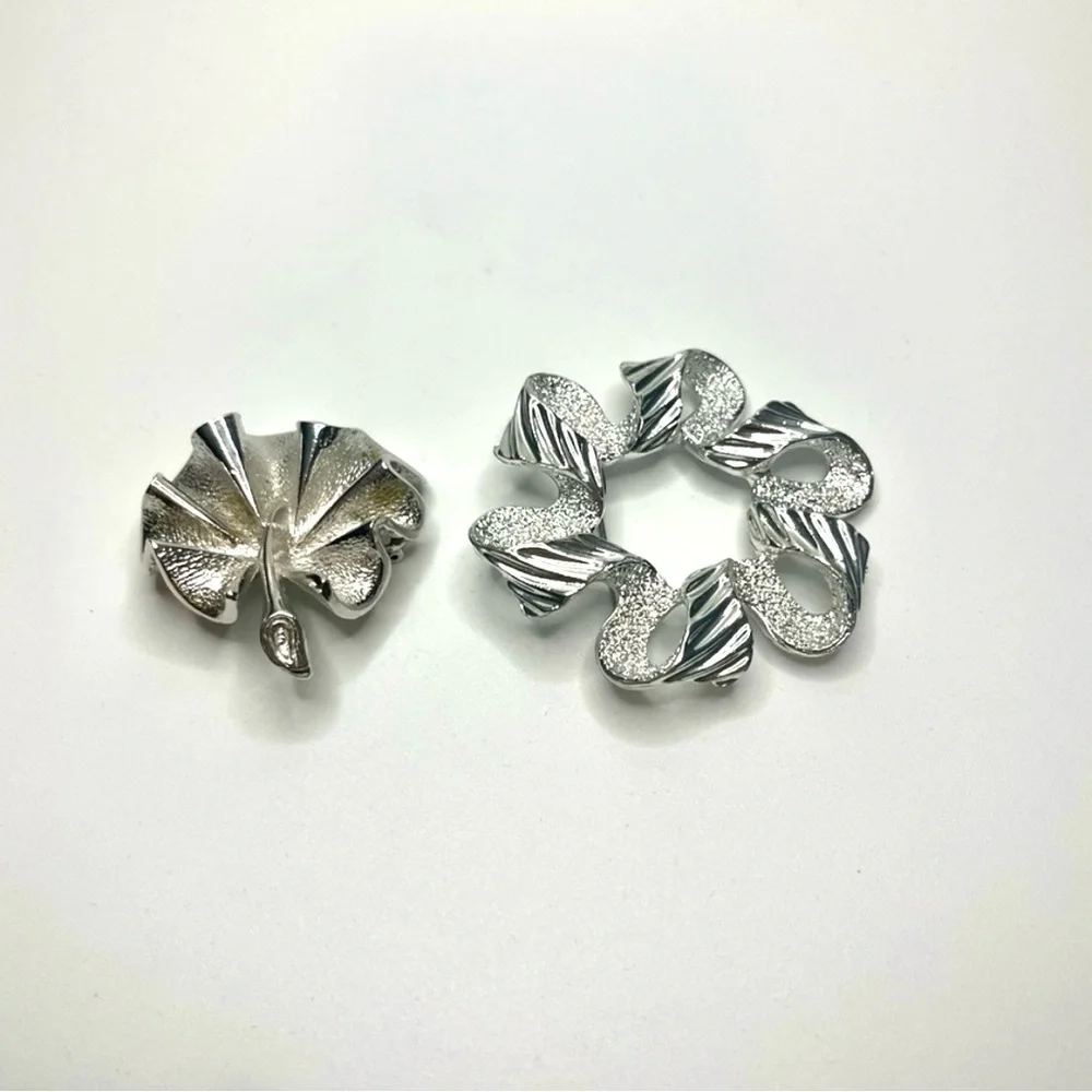 Two Elegant Silver tone Sarah Coventry brooches.